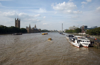 Boats in river with city in background