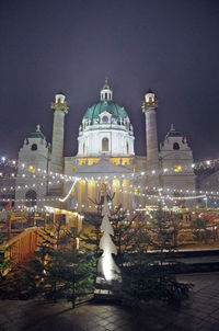 Illuminated building against sky at night