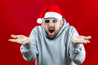 Portrait of man wearing mask against red background