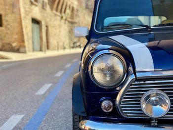 Close-up of vintage car on road