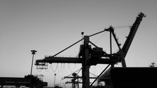 Low angle view of crane against clear sky