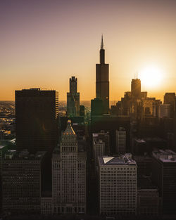 Modern buildings in city during sunset