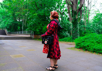 Full length of woman standing on footpath