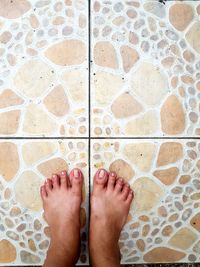 Low section of person standing on tiled floor