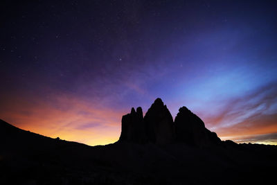 Low angle view of rock formation against sky during dusk