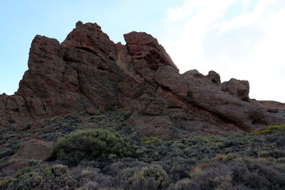 Low angle view of rock formations against sky