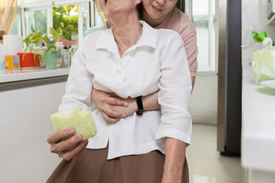 Midsection of woman holding food