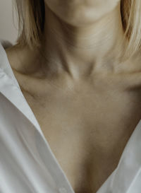 Close-up of a young woman's neck and collarbone. lines on the neck. wrinkles, age-related changes,