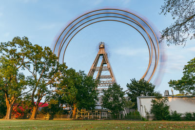 Low angle view of ferris wheel against sky