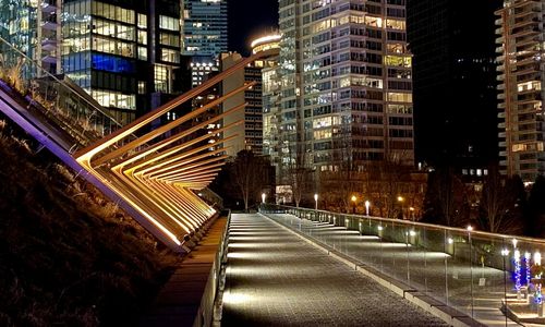 Illuminated street amidst buildings at night