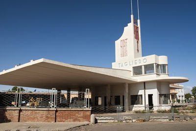 Low angle view of building against clear blue sky