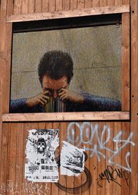 Close-up of man with text on wood
