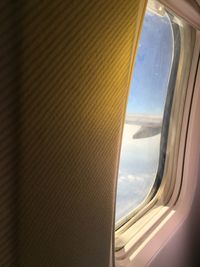 Airplane wing seen through airplane window