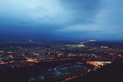 Aerial view of city against cloudy sky