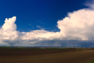 Scenic view of landscape against cloudy sky