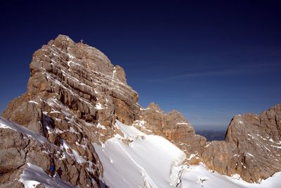 Scenic view of snowcapped mountains against blue sky