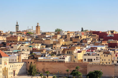 Buildings in city against clear sky