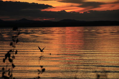 Scenic view of lake against sky during sunset