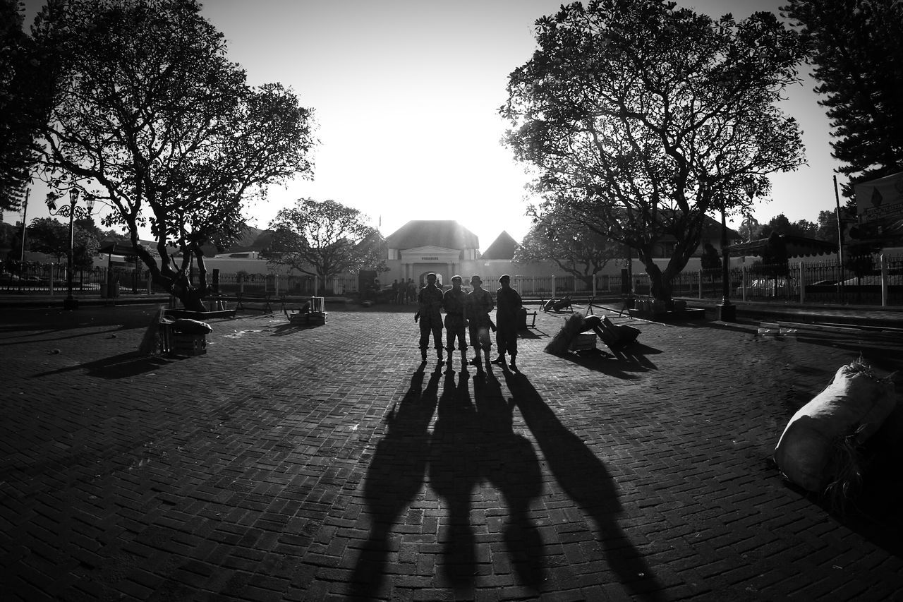 SILHOUETTE PEOPLE WALKING ON ROAD AGAINST SKY