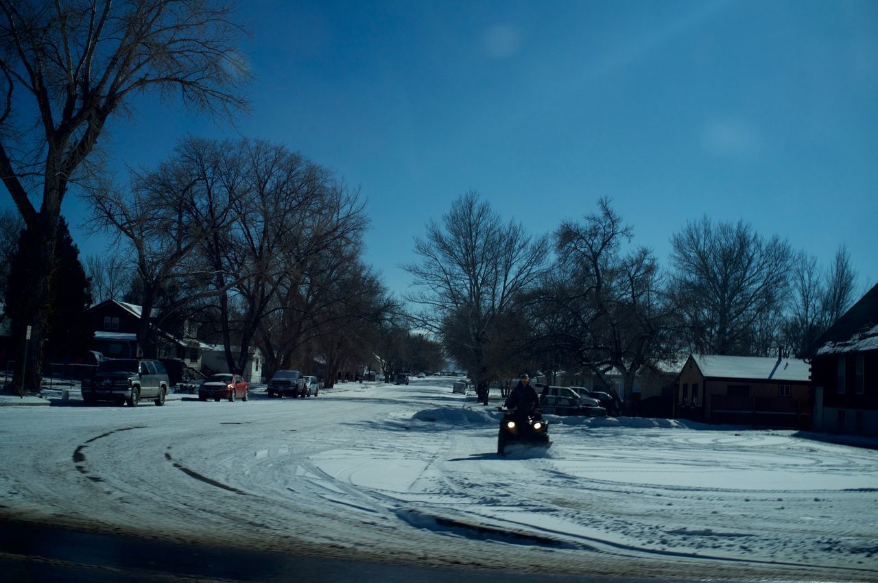 VIEW OF SNOW COVERED ROAD IN CITY