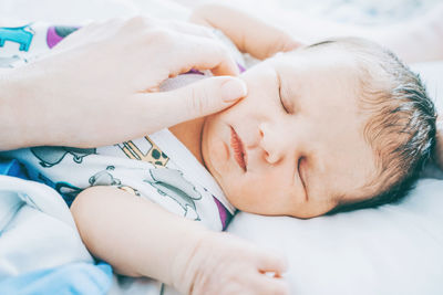 Cute baby sleeping with mother in hospital