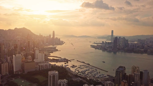 High angle view of city buildings against sky during sunset