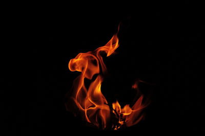 Close-up of fire over black background