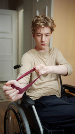 Portrait of young man sitting at home