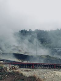 Smoke emitting from train against sky