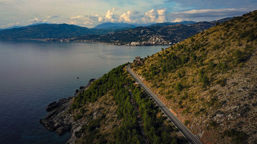 High angle view of sea and mountains against sky