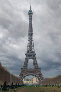 Low angle view of eiffel tower against cloudy sky