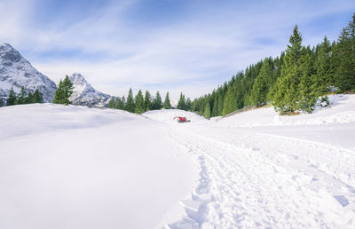 Snow covered landscape against sky