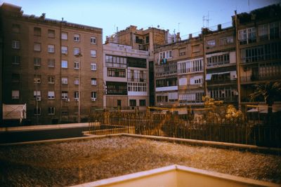 Buildings in city against clear sky