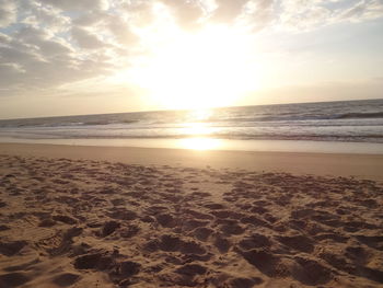 Scenic view of beach against sky during sunset