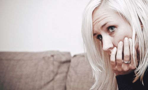 Close-up of thoughtful woman looking away at home