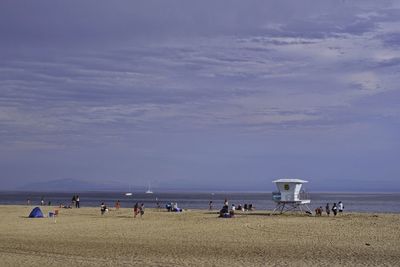 People on beach against sky