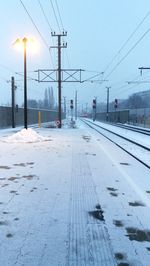 View of railroad tracks against clear sky during winter