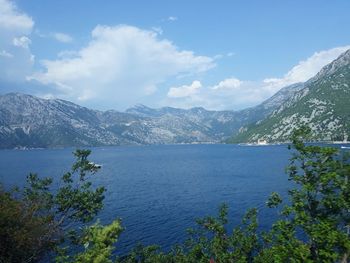 Scenic view of sea and mountains against sky