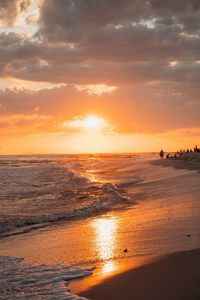 Scenic view of beach against sky during sunset