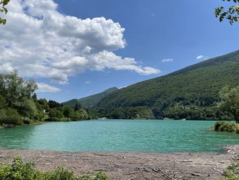 Scenic view of lake and mountains against sky