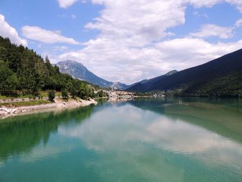 Scenic view of lake and mountains against sky