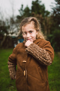 Portrait of smiling girl standing on land