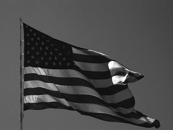 Low angle view of american flag against sky