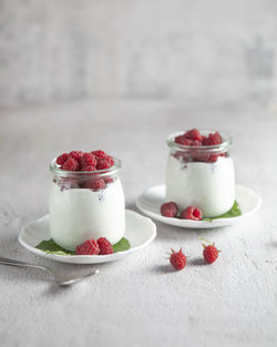 Close-up of two raspberry dessert on table