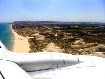 Aerial view of sea and landscape against clear sky