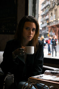 Young woman drinking coffee