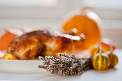 Close-up of herbs with food on table