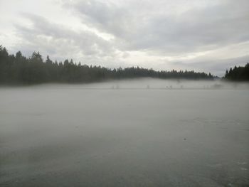 Scenic view of lake against sky during winter