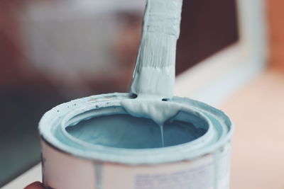 Close up of paint brush in can