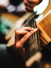 Cropped hand playing guitar